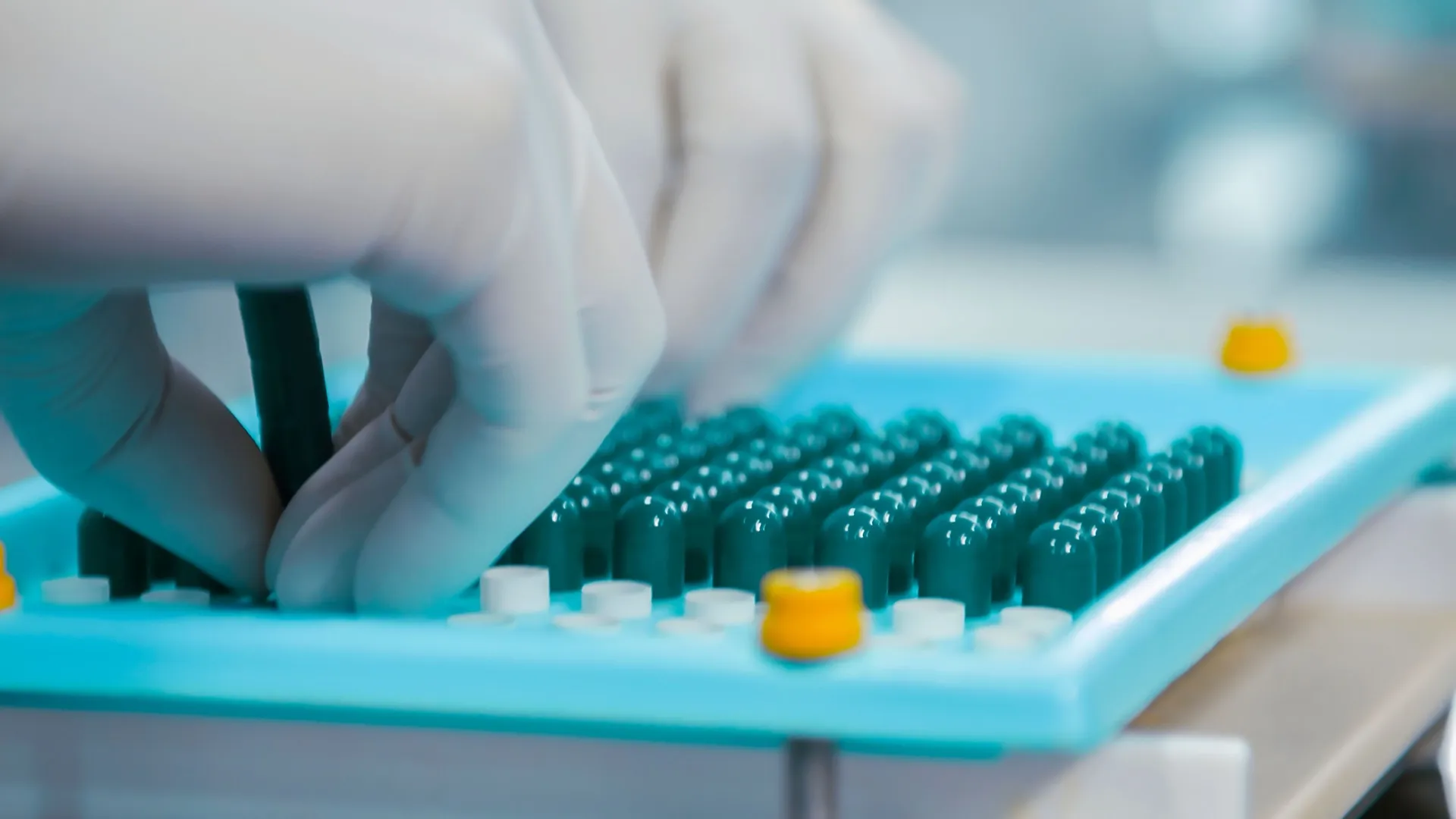 Technicians working inside a pharmaceutical laboratory.